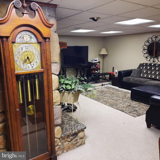 carpeted living room featuring a paneled ceiling