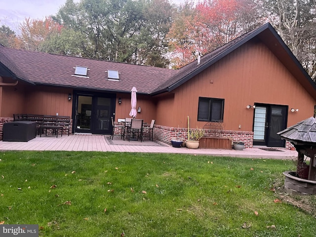 rear view of property featuring a patio area and a yard