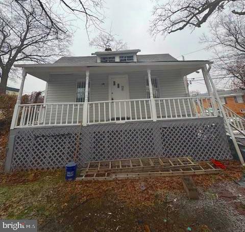 back of house featuring covered porch