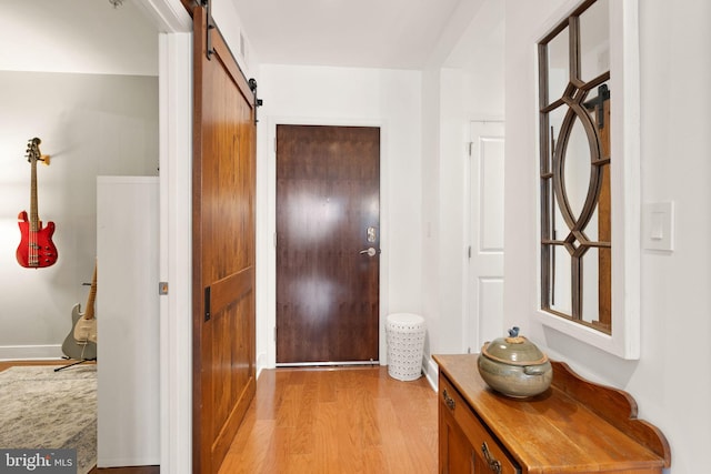 interior space with light hardwood / wood-style floors and a barn door