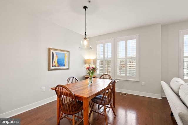 dining space featuring dark hardwood / wood-style flooring