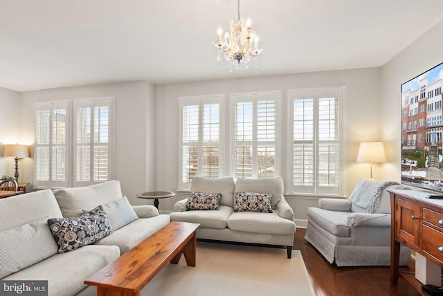 living room with a chandelier and wood-type flooring