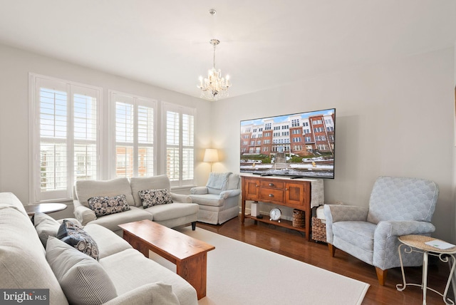 living room featuring dark hardwood / wood-style flooring and a chandelier