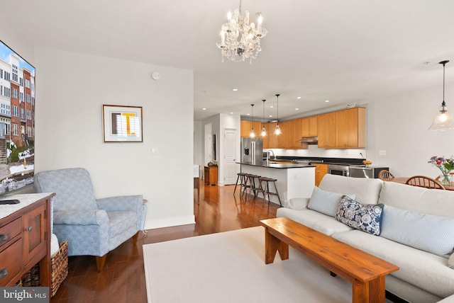 living room with dark hardwood / wood-style flooring and a chandelier