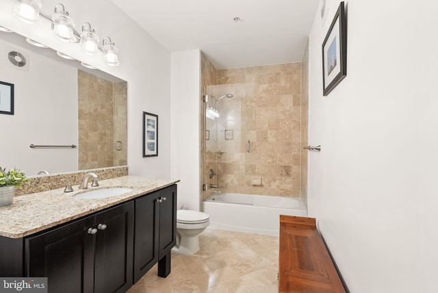 full bathroom featuring toilet, vanity, and tiled shower / bath