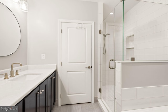 bathroom featuring an enclosed shower, vanity, and tile patterned flooring