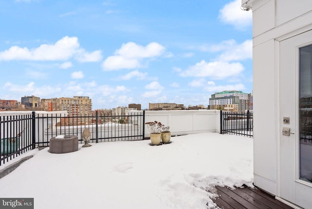 snowy yard featuring a balcony