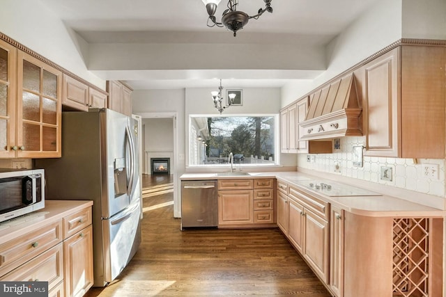 kitchen featuring stainless steel appliances, dark hardwood / wood-style floors, custom exhaust hood, a chandelier, and light brown cabinets