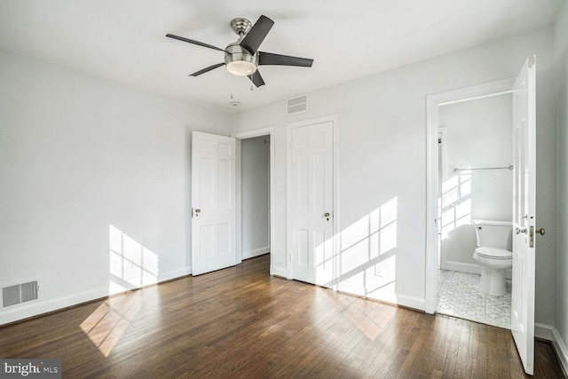 unfurnished bedroom featuring dark hardwood / wood-style flooring, connected bathroom, a closet, and ceiling fan