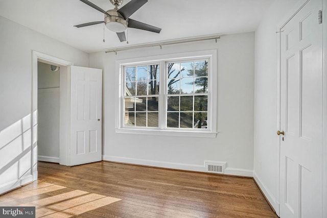 unfurnished bedroom featuring wood-type flooring and ceiling fan