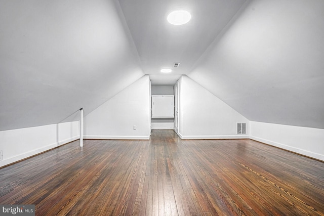 additional living space with dark hardwood / wood-style flooring and lofted ceiling