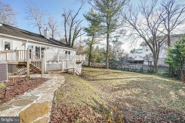 view of yard featuring a wooden deck and central AC