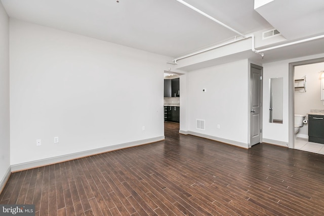 unfurnished living room with dark hardwood / wood-style flooring