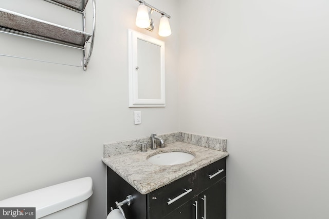 bathroom with toilet and vanity