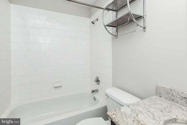 full bathroom with toilet, tiled shower / bath, and vanity