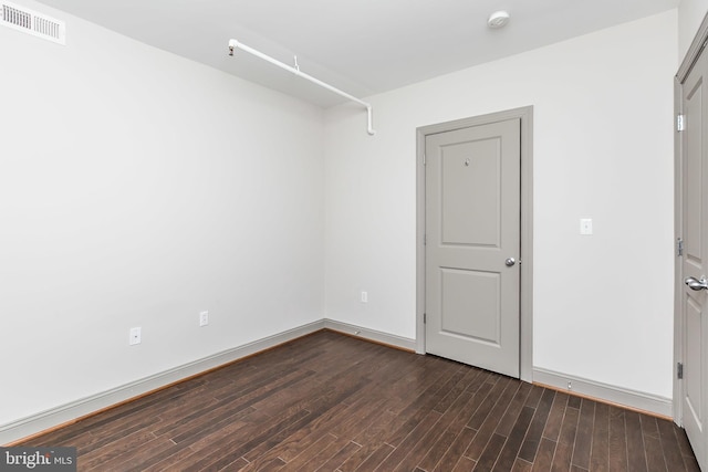 spare room featuring dark hardwood / wood-style flooring