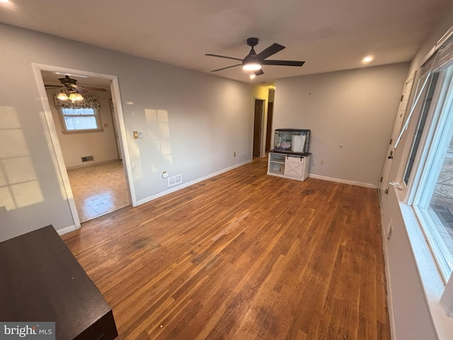 unfurnished living room featuring hardwood / wood-style flooring and ceiling fan