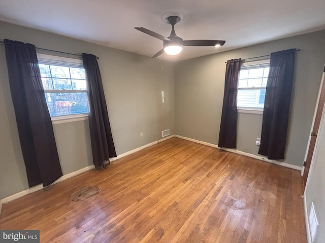 empty room featuring ceiling fan and wood-type flooring