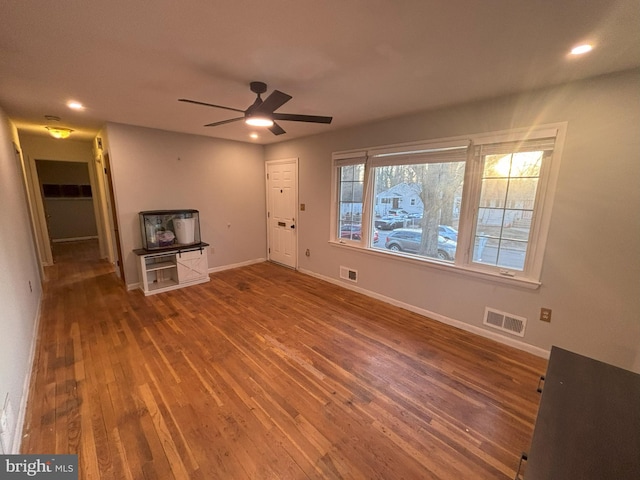 unfurnished living room featuring hardwood / wood-style flooring and ceiling fan