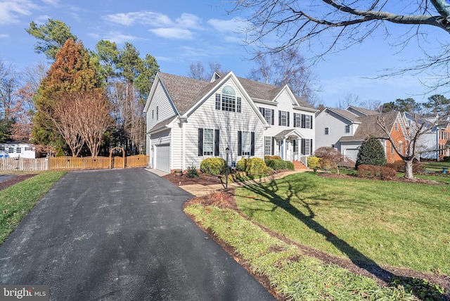 view of front of property featuring a garage and a front lawn