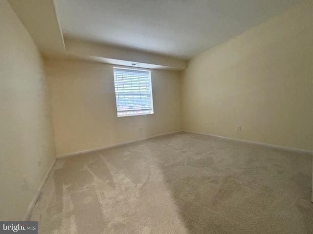 empty room featuring light carpet