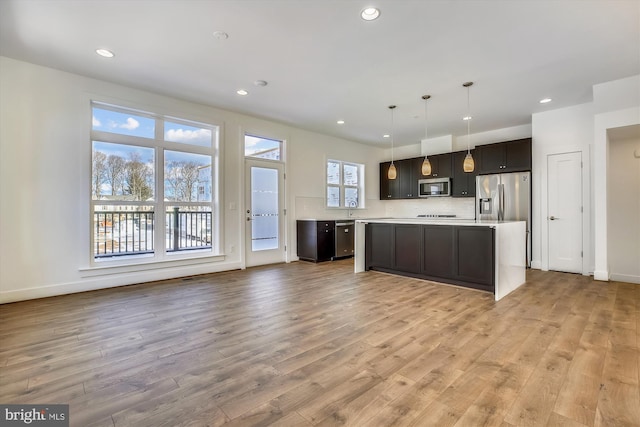 3234 Royal Fern Pl, Rockville, MD 20852 - kitchen with a kitchen island, light countertops, stainless steel appliances, and light wood-type flooring