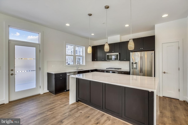 3234 Royal Fern Pl, Rockville, MD 20852 - kitchen featuring light countertops, light wood-style flooring, stainless steel appliances, and backsplash