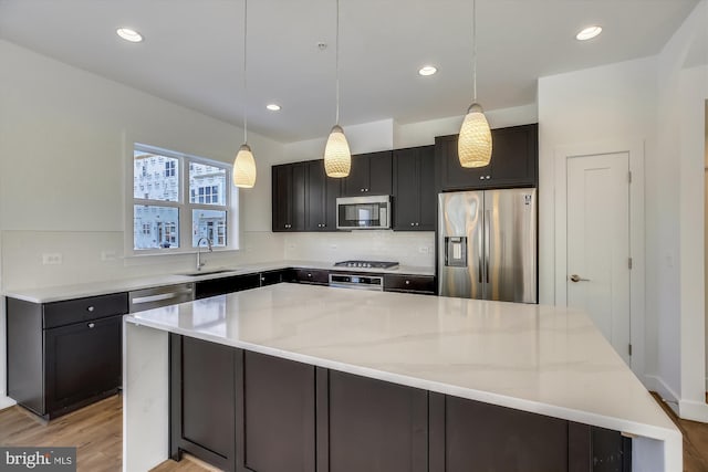3234 Royal Fern Pl, Rockville, MD 20852 - kitchen with a sink, light wood finished floors, a large island, light stone countertops, and appliances with stainless steel finishes