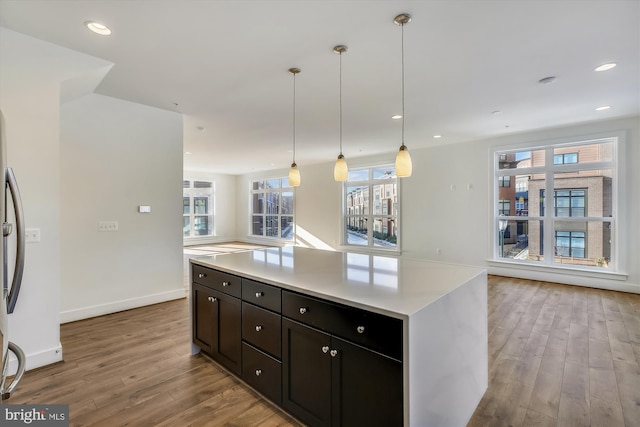 3234 Royal Fern Pl, Rockville, MD 20852 - kitchen with light countertops, baseboards, wood finished floors, recessed lighting, and hanging light fixtures