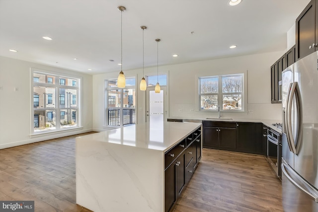3234 Royal Fern Pl, Rockville, MD 20852 - kitchen with light wood-style flooring, recessed lighting, a kitchen island, appliances with stainless steel finishes, and a sink