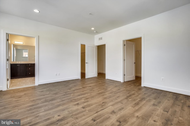 3234 Royal Fern Pl, Rockville, MD 20852 - unfurnished bedroom with light wood-style floors, a closet, and a spacious closet