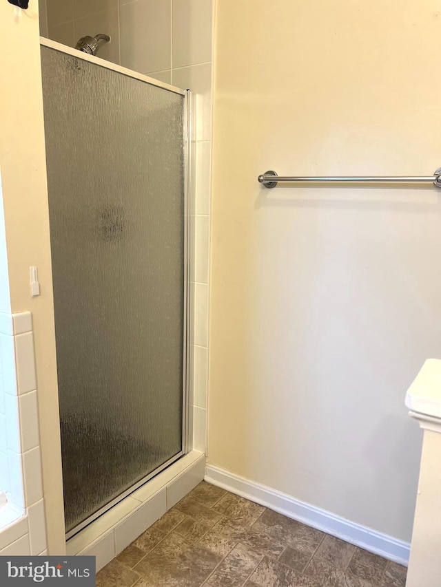 bathroom featuring a shower with shower door