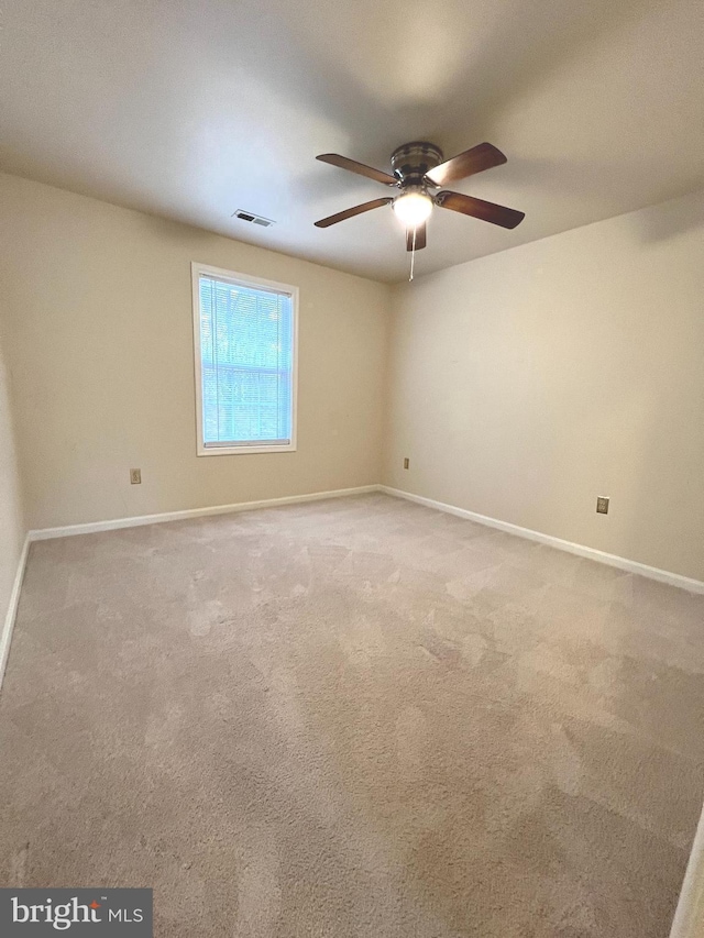 carpeted empty room with ceiling fan