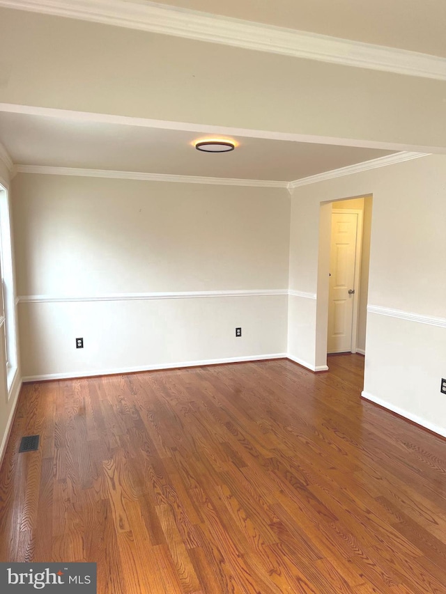 unfurnished room with wood-type flooring and crown molding