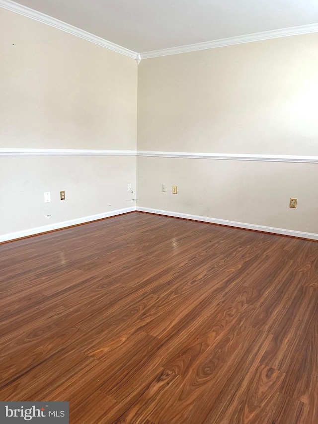 spare room with dark hardwood / wood-style floors and crown molding