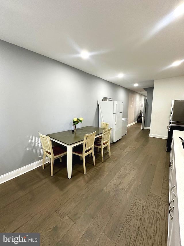 dining space with dark wood-type flooring