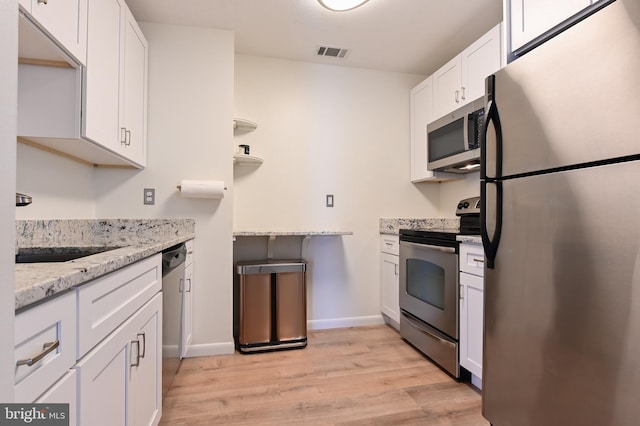 kitchen with visible vents, open shelves, white cabinetry, stainless steel appliances, and light wood finished floors