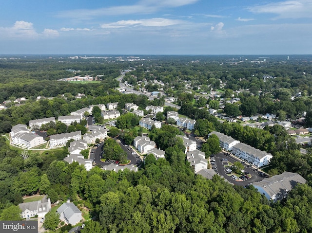 birds eye view of property featuring a residential view and a forest view