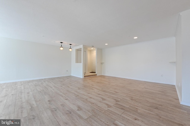 unfurnished room featuring recessed lighting, baseboards, and light wood-style floors