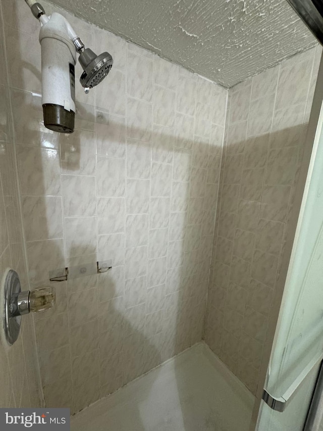 bathroom with a tile shower