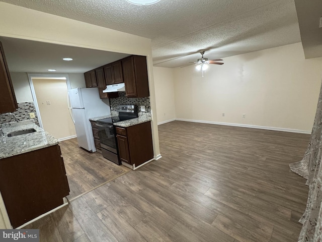 kitchen featuring sink, white refrigerator, stainless steel electric range oven, and tasteful backsplash