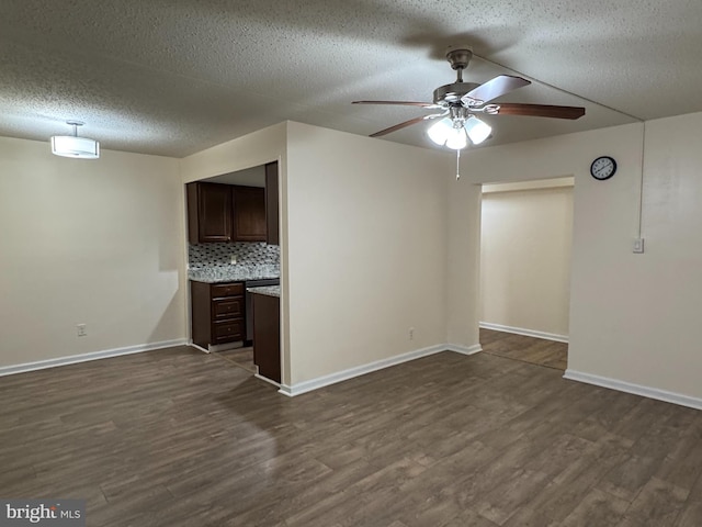 unfurnished living room featuring ceiling fan, a textured ceiling, and dark hardwood / wood-style flooring