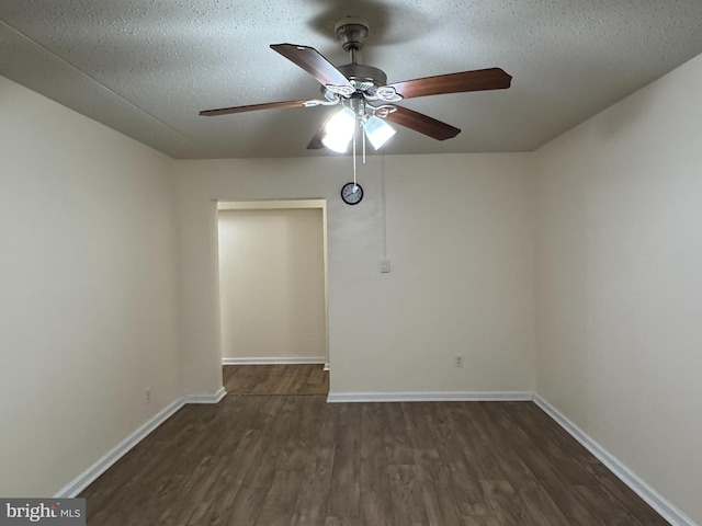 empty room with ceiling fan, dark hardwood / wood-style floors, and a textured ceiling