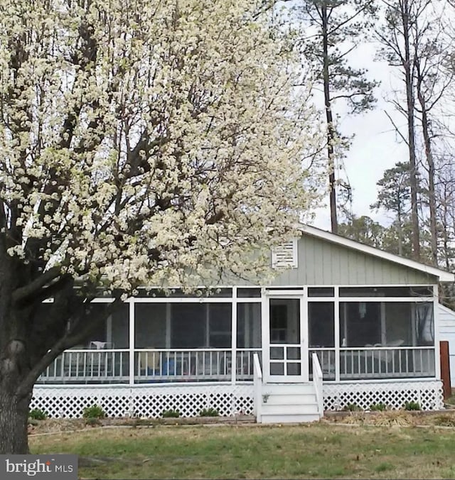 rear view of property with a sunroom