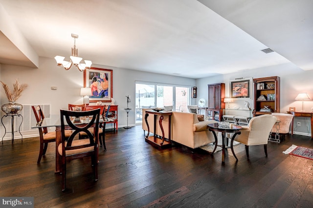 living room featuring dark wood-type flooring and a chandelier