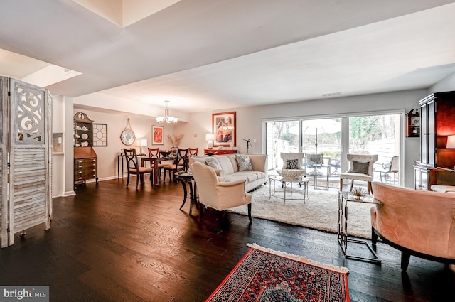 living room featuring dark hardwood / wood-style flooring and a notable chandelier