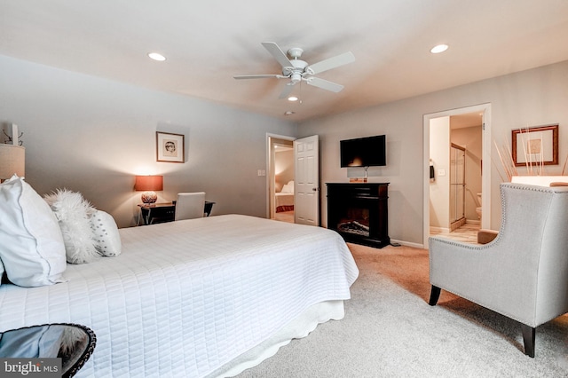 carpeted bedroom with ceiling fan and ensuite bathroom