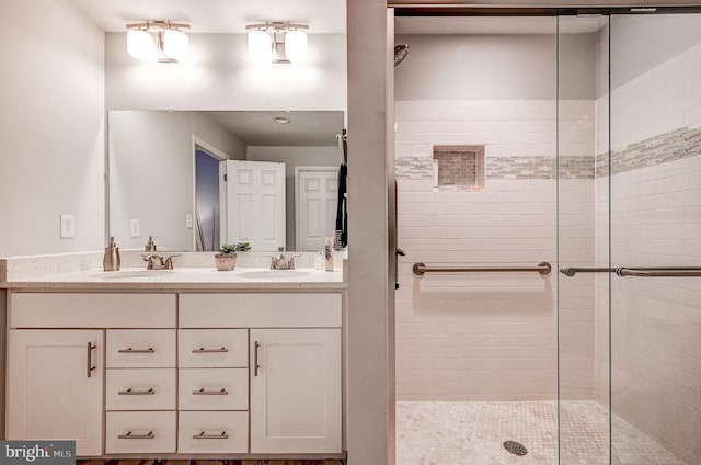 bathroom featuring vanity and a shower with door