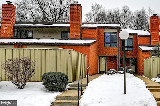 view of snow covered rear of property