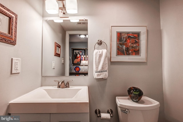 bathroom with toilet and vanity